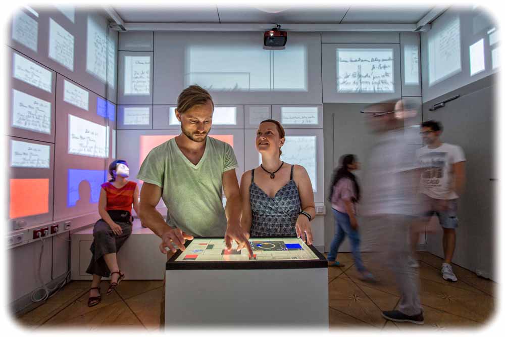 Ingenieure und Besucher testen im Mondrian-Raum im Barkhausen-Institut Dresden aus, wie sich abstrakte Entwürfe variieren lassen - und was passiert, denn der Datenschutz bröckelt. Das Zimmer ist teil des "Open Labs". Foto: Robert Arnold für die LHD