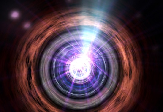 Die künstlerische Visualisierung zeigt eine Blazar-Galaxis mit einem Schwarzen Loch in der Mitte, das in der Senkrechten einen hochbeschleunigten Partikelstrahl aussendet. Abb.: NASA, ESA