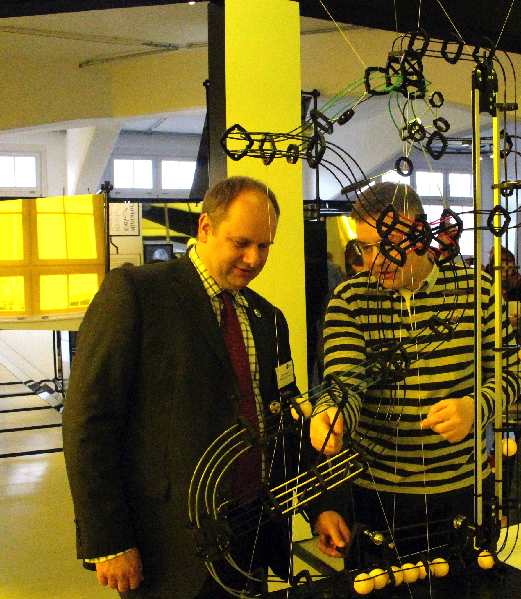 Dresdens Wirtschaftsbürgermeister Dirk Hilbert (FDP) probiert das Kugelspiel aus, das die Funktionsweise eines Transistors veranschaulicht - die Kugeln stehen dabei für Elektronen. Foto: Heiko Weckbrodt