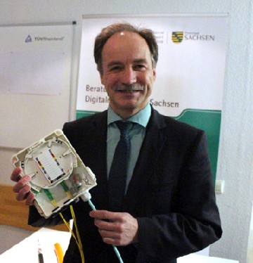 Sachsen Wirtschaftsminister Sven Morlok (FDP) begutachtet in der neuen Breitband-Beratungsstelle in Dresden einen Verteiler, wie er für den Anschluss von Wohnhäusern an schnelle Glasfaserkabel gebraucht wird. Foto: Heiko Weckbrodt