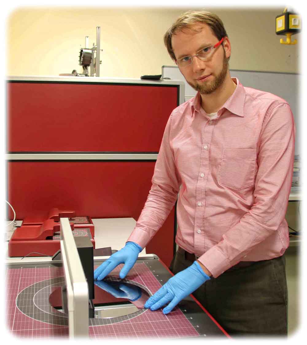 Suragus-Chef Marcus Klein legt eine Siliziumscheibe ("Wafer") in ein Messgerät ein, das Wiebelströme die dünnen Schichten sendet, um Defekte und Zuverlässigkeit der Schicht zu erkennen. Foto: Heiko Weckbrodt