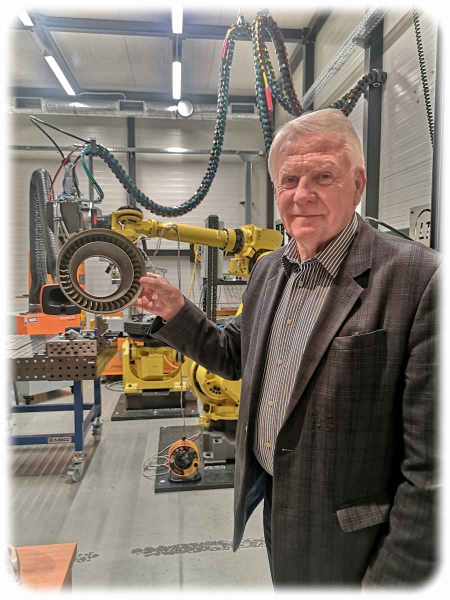 Prof. Edward Chlebus von der Technischen Universität Breslau zeigt im Produktionszentrum CAMT ein Triebwerkteil aus dem 3D-Drucker. Foto: Heiko Weckbrodt